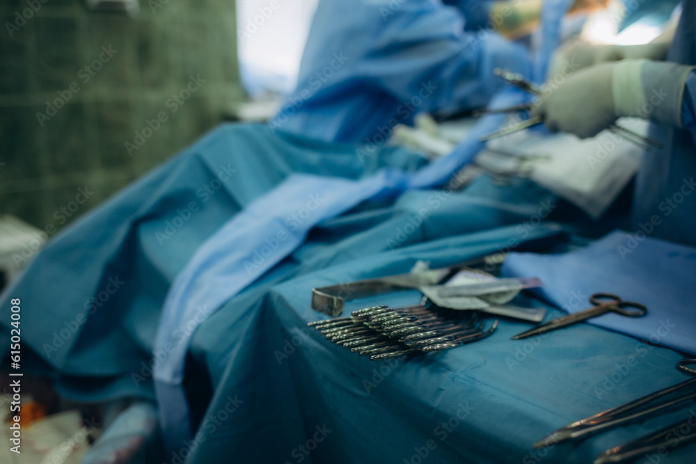 Surgical clamps and medical equipment on surgical tray.Surgical