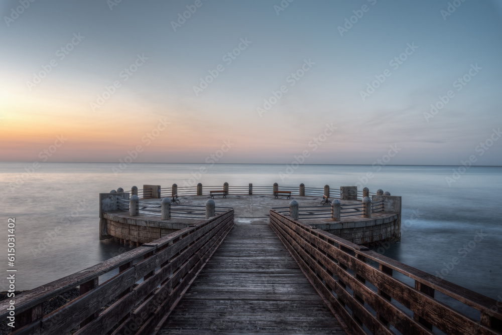 Morning on the pier and the roundabout overlooking the sea with the splendid colors of sunrise