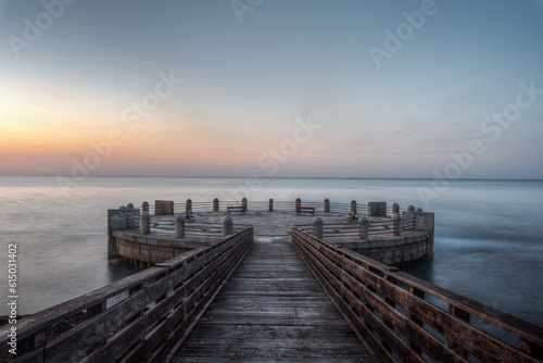 Morning on the pier and the roundabout overlooking the sea with the splendid colors of sunrise