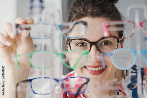 Happy woman wearing glasses at the eyewear store