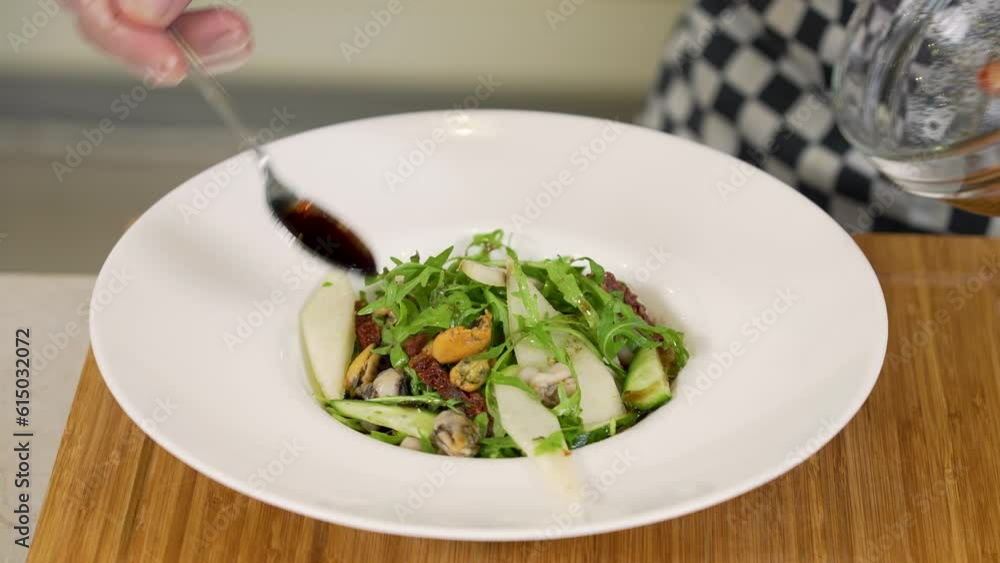 Serving seafood, pear and dried tomatoed salad Serving seafood, pear and dried tomatoed salad