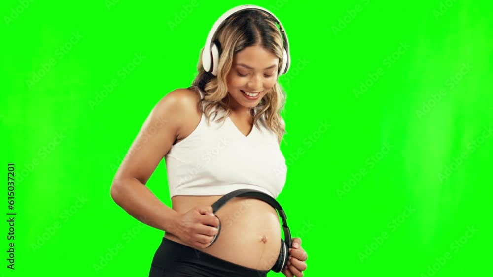 Happy, pregnant woman or headphones on stomach in studio for growth or baby development on green screen. Pregnancy music, relax or mother to be streaming radio audio on belly for healthy maternity Happy, pregnant woman or headphones on stomach in studio for growth or baby development on green screen. Pregnancy music, relax or mother to be streaming radio audio on belly for healthy maternity