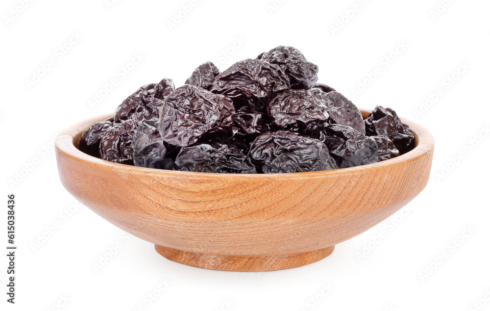 Prunes in wooden bowl isolated on white background. Prunes in wooden bowl isolated on white background.