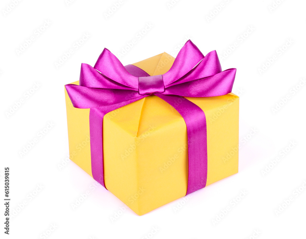 Yellow gift box with purple ribbon bow isolated on white background. Yellow gift box with purple ribbon bow isolated on white background.