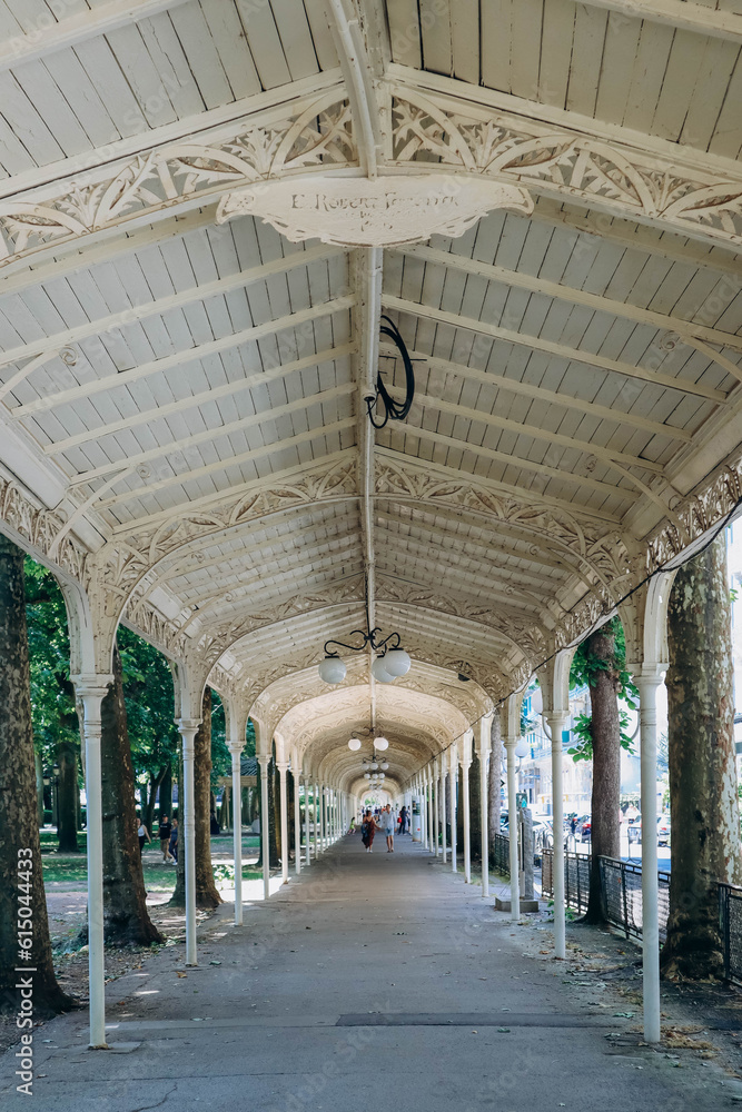 Vichy, France - 19 June 2023: Famous promenades (canopies for walking) at the Parc des Sources of Vichy