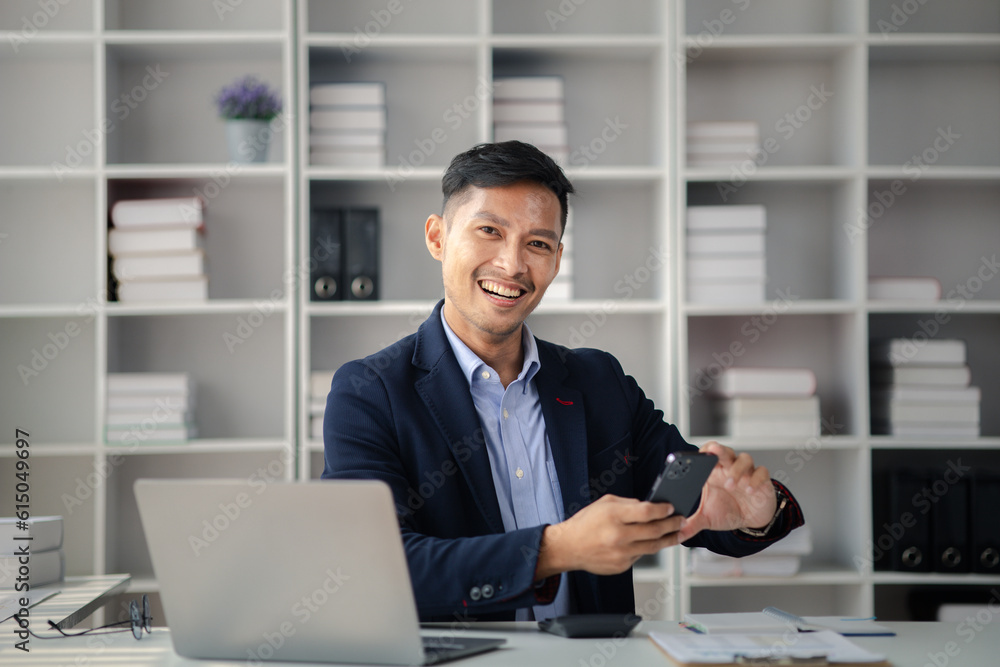 Man in the office, he is young businessman, modern business management, start-up company run by young people, modern entrepreneur with new ideas. to be a business leader. Startup company concept. Man in the office, he is young businessman, modern business management, start-up company run by young people, modern entrepreneur with new ideas. to be a business leader. Startup company concept.