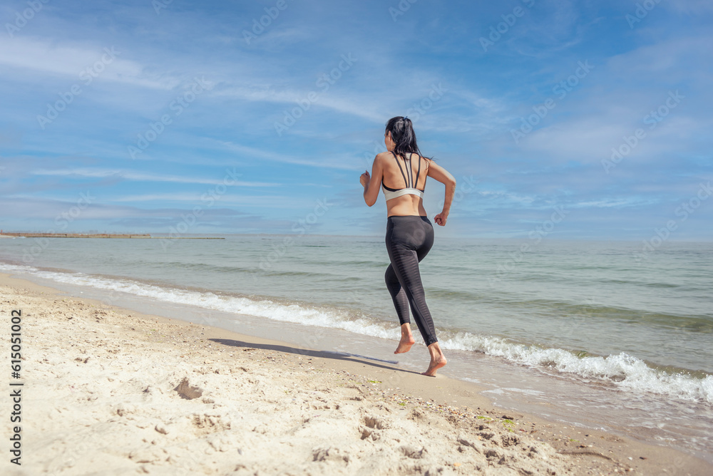 Fitness Girl running on the beach