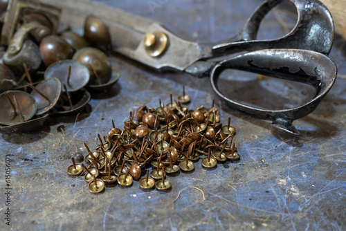 Wallpaper Mural Upholstery nails and scissors on the workbench in a craft workshop, copy space, selected focus Torontodigital.ca