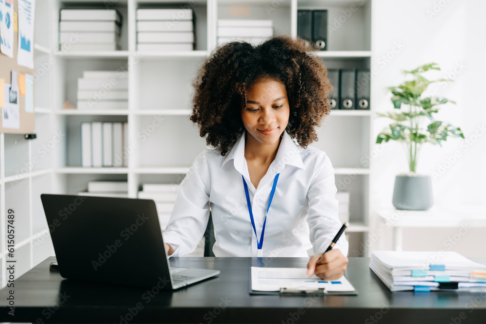 Business woman using tablet and laptop for doing math finance on an office desk, tax, report, accounting, statistics, and analytical research concept in office Business woman using tablet and laptop for doing math finance on an office desk, tax, report, accounting, statistics, and analytical research concept in office