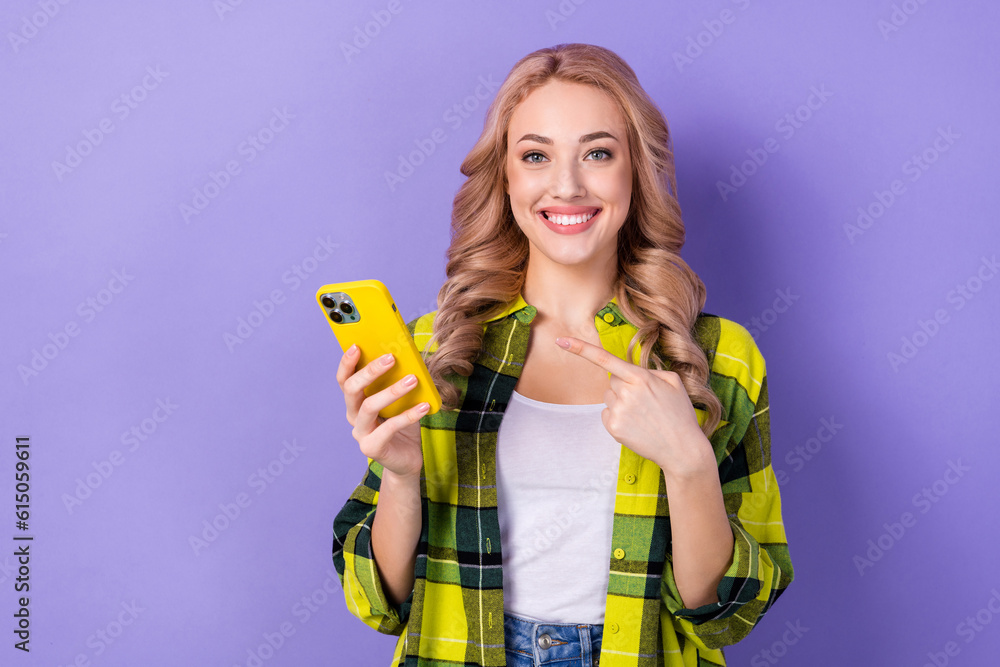 Photo of young promoter girl wavy blonde recommend point finger new web service online wear checkered shirt isolated on purple background Photo of young promoter girl wavy blonde recommend point finger new web service online wear checkered shirt isolated on purple background