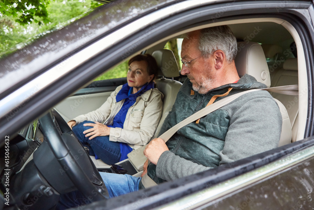 Senior man wearing seatbelt while traveling in car Senior man wearing seatbelt while traveling in car