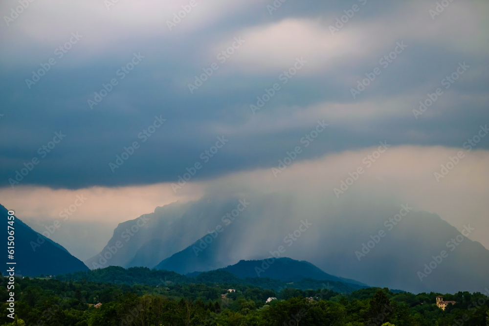 Dark clouds and rain over mountains in Dolomites, Italy