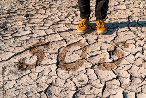  Man standing on the cracked land with the word SOS