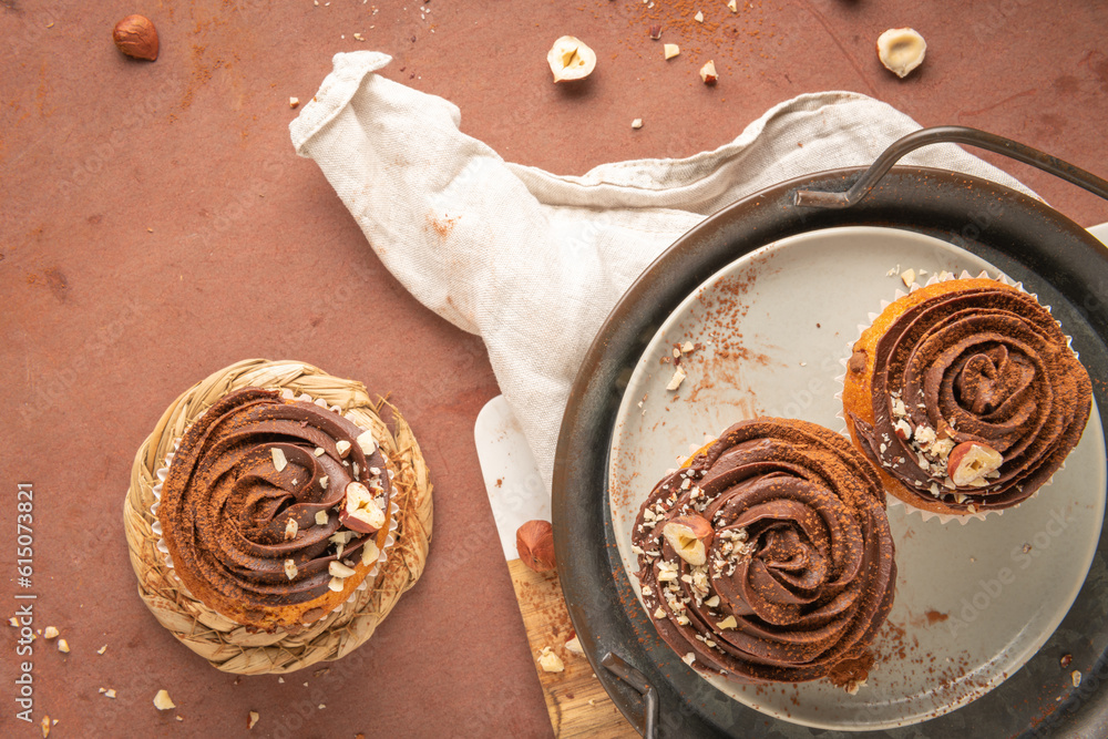 Chocolate chip muffins decorated with chocolate ganache and hazelnut Chocolate chip muffins decorated with chocolate ganache and hazelnut