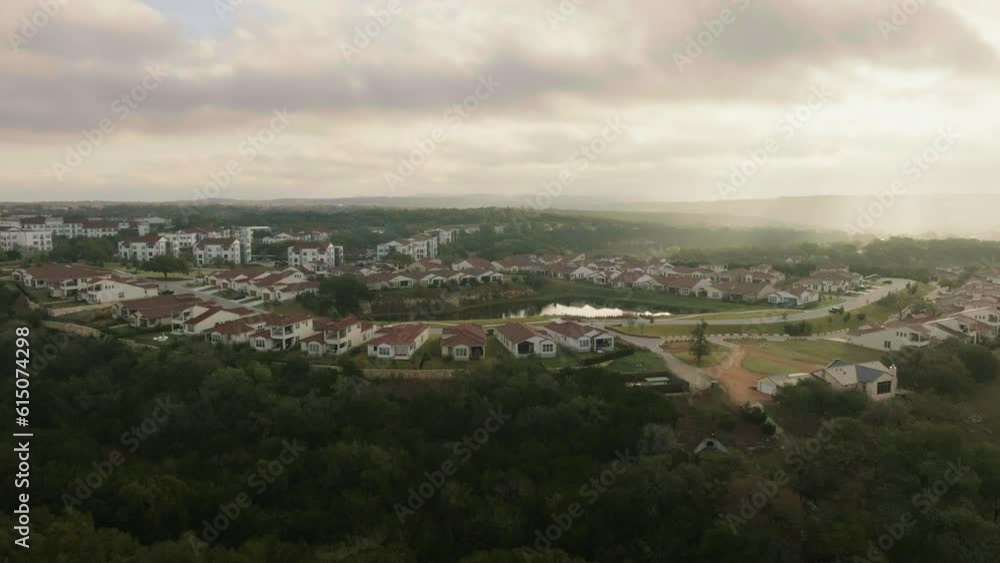 Aerial drone flyover of Hill Country, Austin, Texas master plan suburban real estate community neighborhood at sunrise Aerial drone flyover of Hill Country, Austin, Texas master plan suburban real estate community neighborhood at sunrise