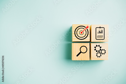 Wooden cube block step with Action Plan, Goal, and Target icons. Success and business target concept. Project management and company strategy on a blue background.