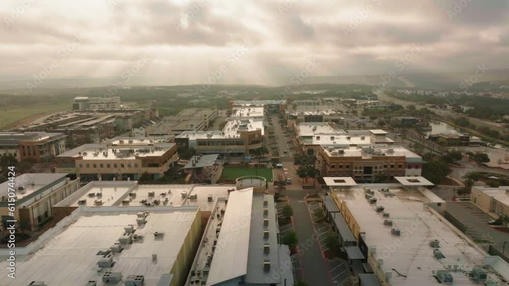 Austin, Texas Hill Country Galleria mall and neighborhood community shopping center aerial drone flyover pan at sunrise Austin, Texas Hill Country Galleria mall and neighborhood community shopping center aerial drone flyover pan at sunrise
