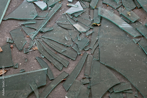 Cracked broken destroyed glass abstract texture on the cement floor background at Thailand.     photo