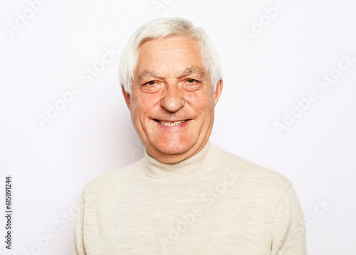 Close up portrait of happy senior man over white background