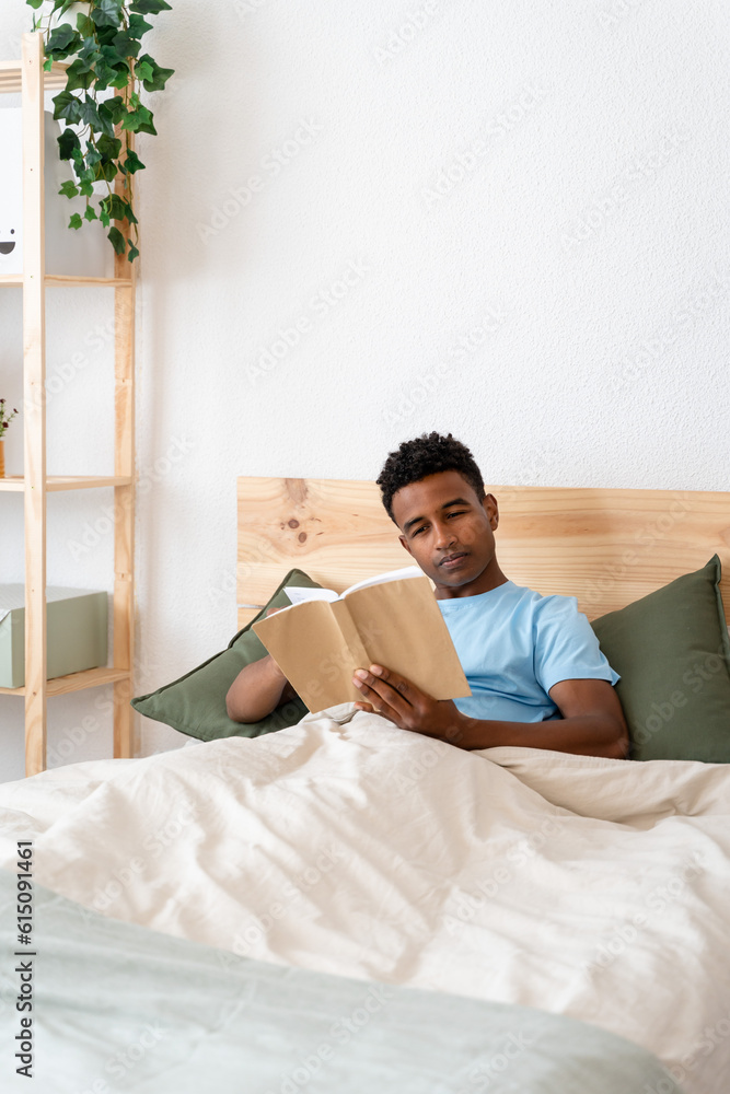 Man enjoying a book in bed on sunday. Man enjoying a book in bed on sunday.