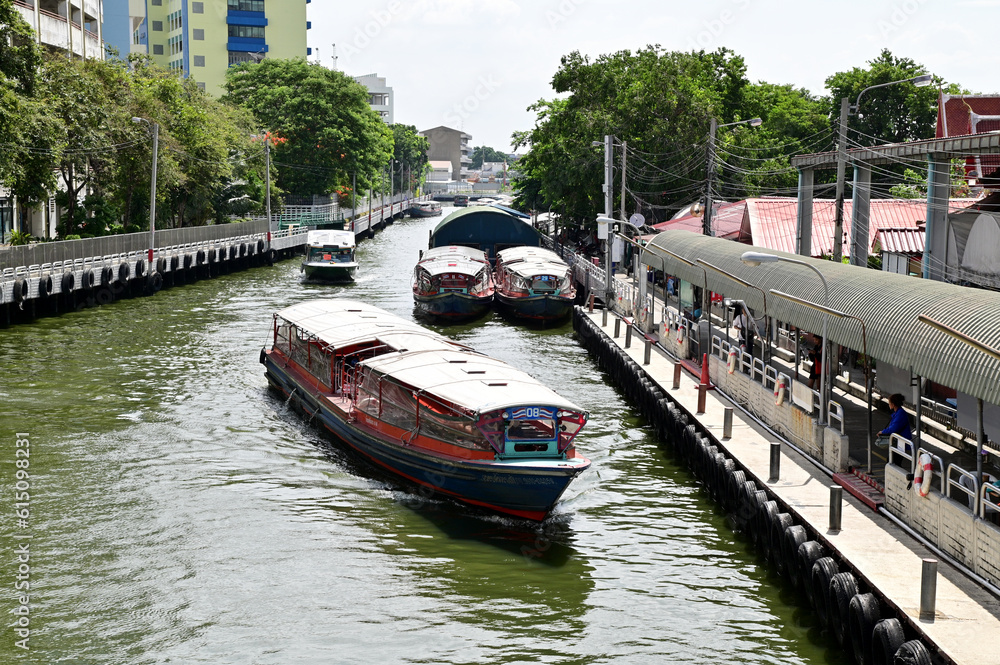 Naklejka premium BANGKOK, THAILAND - June 20, 2023 : Saen Saeb Passenger Boat runs quickly to take passengers to the front station in Saen Saeb Canal at Bangkok, Thailand.