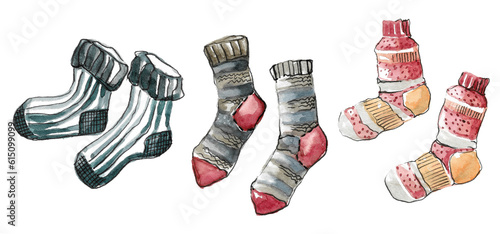 A set of warm autumn hand-knitted woolen socks. Blue socks with stripes, red-orange with ornaments and gray with a red heel. Hand drawn watercolor illustration isolated on white background
