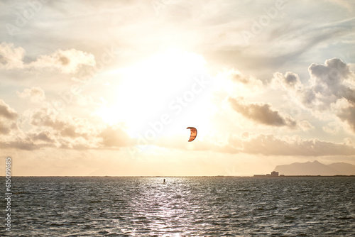 doing kite surfing at sunset on the Lagoon of Marsala, Trapani, Sicily.