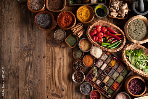 Spices. Collection of spices in bowls on wooden rustic table forming an abstract background.
