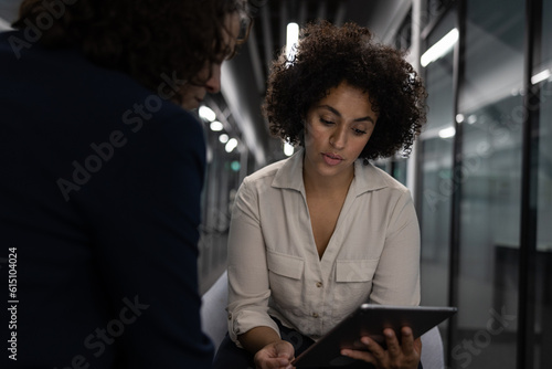Businesswoman in a meeting with a coworker working late in the office photo