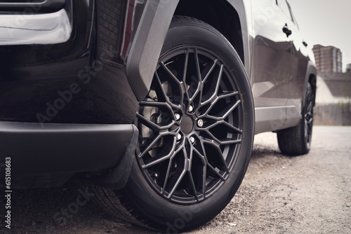 Beautiful black wheel on a car close-up. Concept car service or tire service