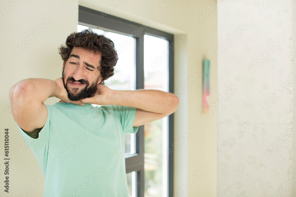 young crazy bearded man feeling anxious, ill, sick and unhappy, suffering a painful neck ache young crazy bearded man feeling anxious, ill, sick and unhappy, suffering a painful neck ache