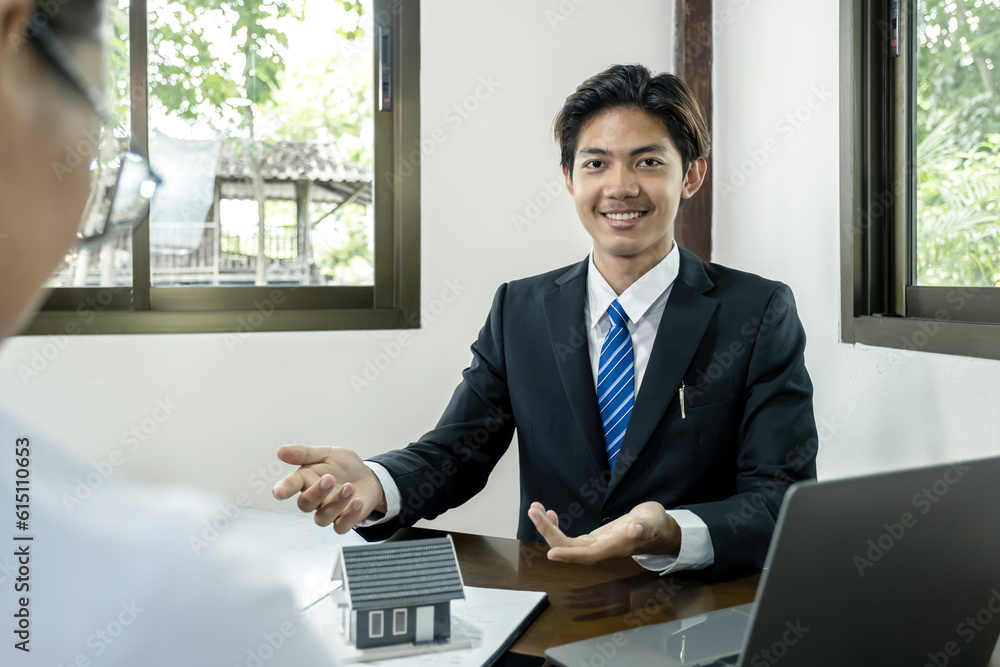 Hand a real estate agent hold the home model, and explain the business contract, rent, buy, mortgage, loan, or home insurance to the buyer woman Hand a real estate agent hold the home model, and explain the business contract, rent, buy, mortgage, loan, or home insurance to the buyer woman