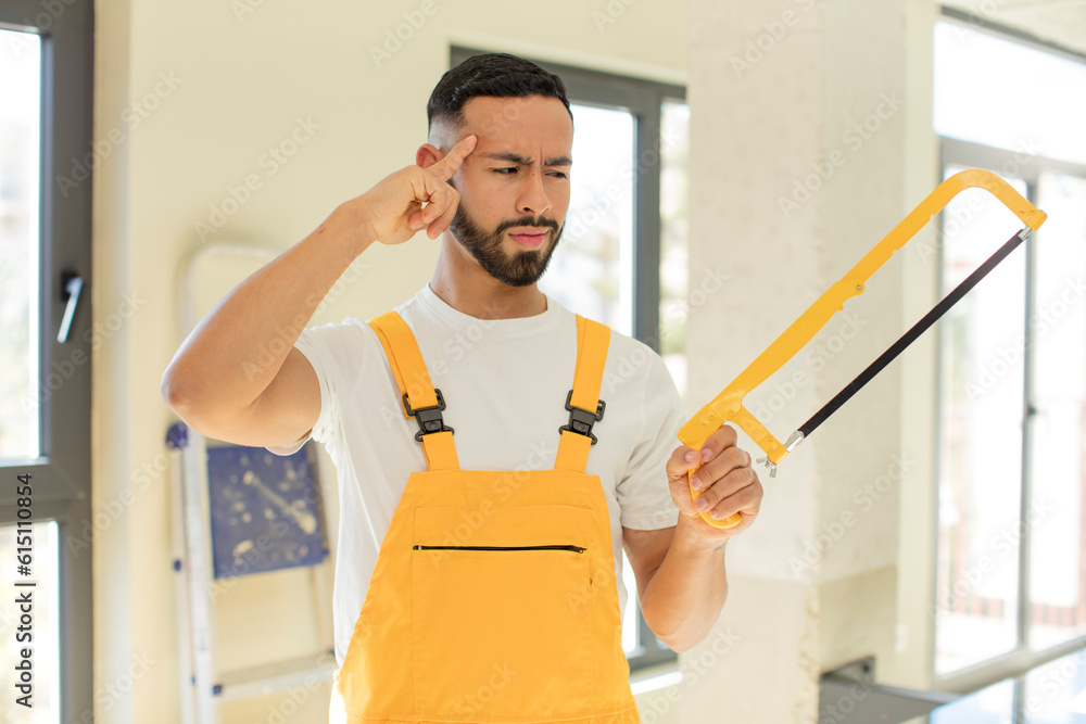arab handsome man arab man looking surprised, realizing a new thought, idea or concept. handyman concept arab handsome man arab man looking surprised, realizing a new thought, idea or concept. handyman concept