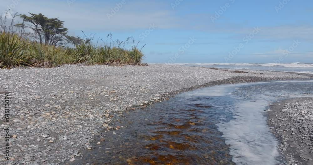 Aerial: River flowing into the ocean. South Island, New Zealand