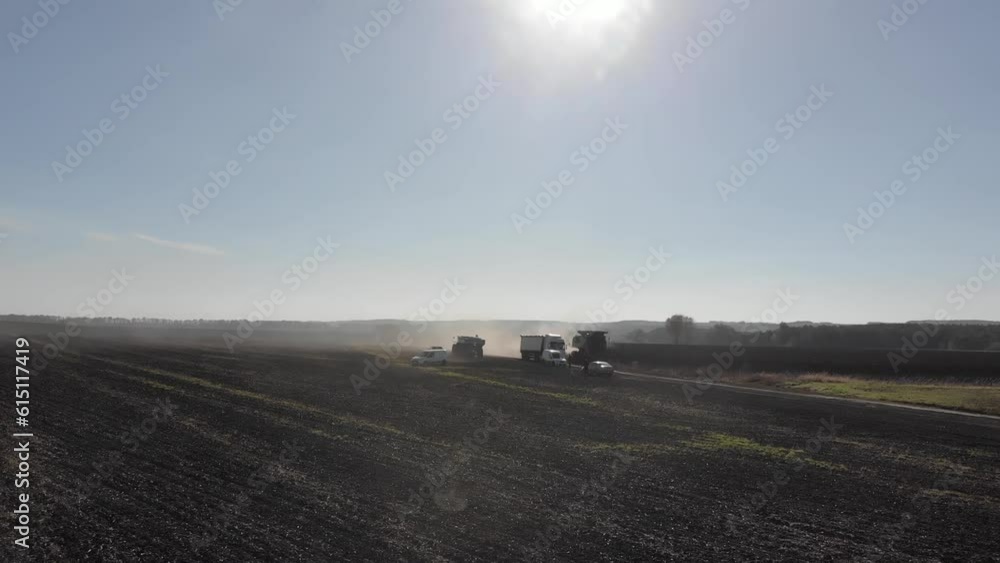 Sunflower harvest with green combine and tractor during the war with Russia in 2022 Sunflower harvest with green combine and tractor during the war with Russia in 2022