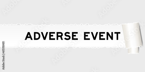 Ripped gray paper background that have word adverse event under torn part