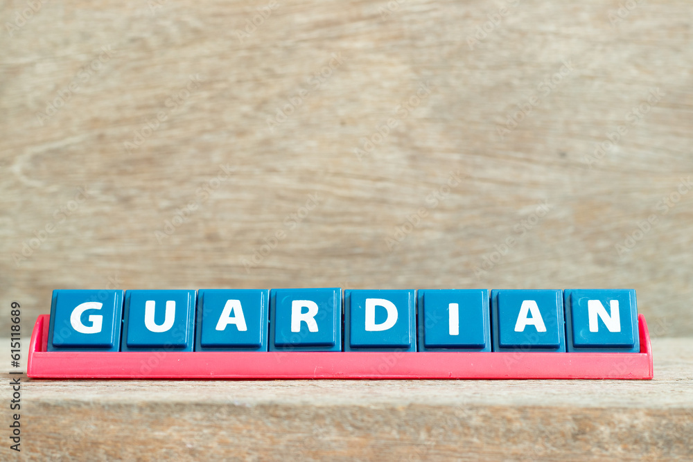 Tile alphabet letter with word guardian in red color rack on wood background Tile alphabet letter with word guardian in red color rack on wood background