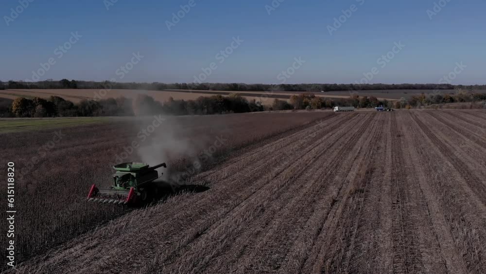 Sunflower harvest with green combine and tractor during the war with Russia in 2022 Sunflower harvest with green combine and tractor during the war with Russia in 2022