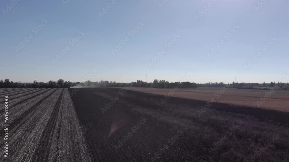 Sunflower harvest with green combine and tractor during the war with Russia in 2022 Sunflower harvest with green combine and tractor during the war with Russia in 2022
