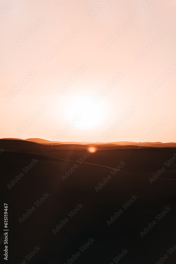Sunset over the desert: A breathtaking display of golden hues transforms the landscape, evoking a sense of serenity and captivating beauty Sunset over the desert: A breathtaking display of golden hues transforms the landscape, evoking a sense of serenity and captivating beauty