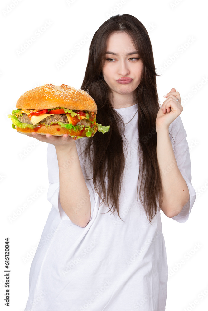 A woman is holding a big barbecue hamburger sandwich on the background. Fast food concept. The girl has a huge hamburger. A woman is holding a big barbecue hamburger sandwich on the background. Fast food concept. The girl has a huge hamburger.