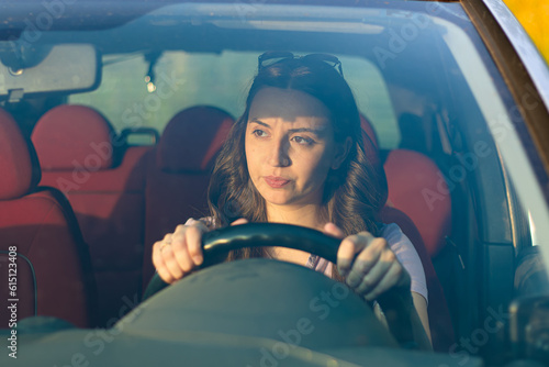 serious woman in the car.Driving a car as a hobby.Renting a car.confident woman driving.problems on the road.emotional girl in the auto.holding the steering wheel.
woman with car.upset girl.portrait