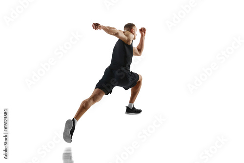 Side bottom view image of young man with muscular, strong, fit body, professional runner in motion against white studio background