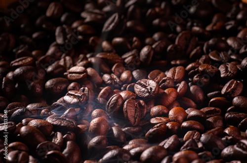 Roast coffee beans with faint smoke or steam from baking. Roast coffee beans before blending or grinding them to make fresh coffee  espresso or drip.