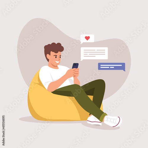 a man (boy) sitting in a bag chair and texting a girl