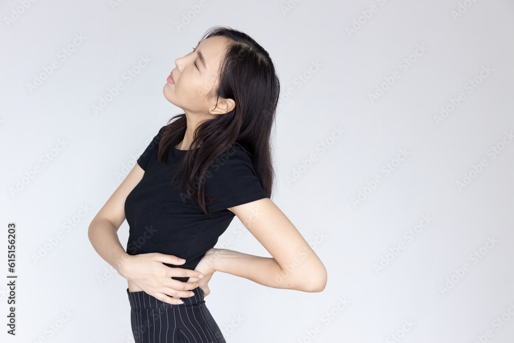 Asian woman sufferring from back pain at lumber spine or spinal herniated disc Asian woman sufferring from back pain at lumber spine or spinal herniated disc