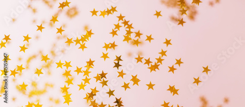 Banner with gold sequins on a pink background. Beautiful confetti in the form of stars