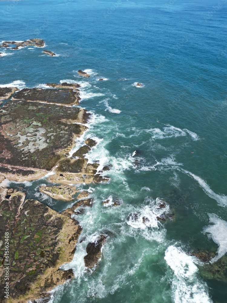 Aerial top down view of waves crashing onto the rocks off the coastline of Dunbar Scotland. Aerial top down view of waves crashing onto the rocks off the coastline of Dunbar Scotland.