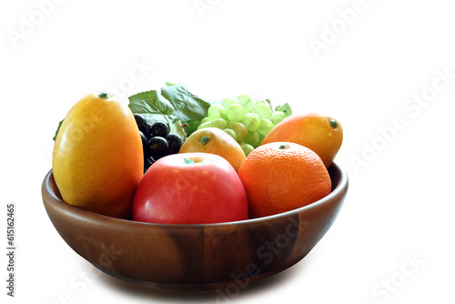 Plastic replica fruit in wooden basket with ripping path.