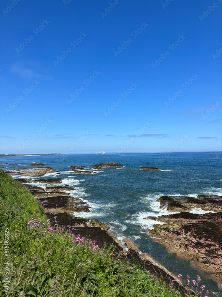 Aerial view of Dunbar in Scotland with the waves crashing onto rocks and views of  landmarks. Dunbar Scotland. 